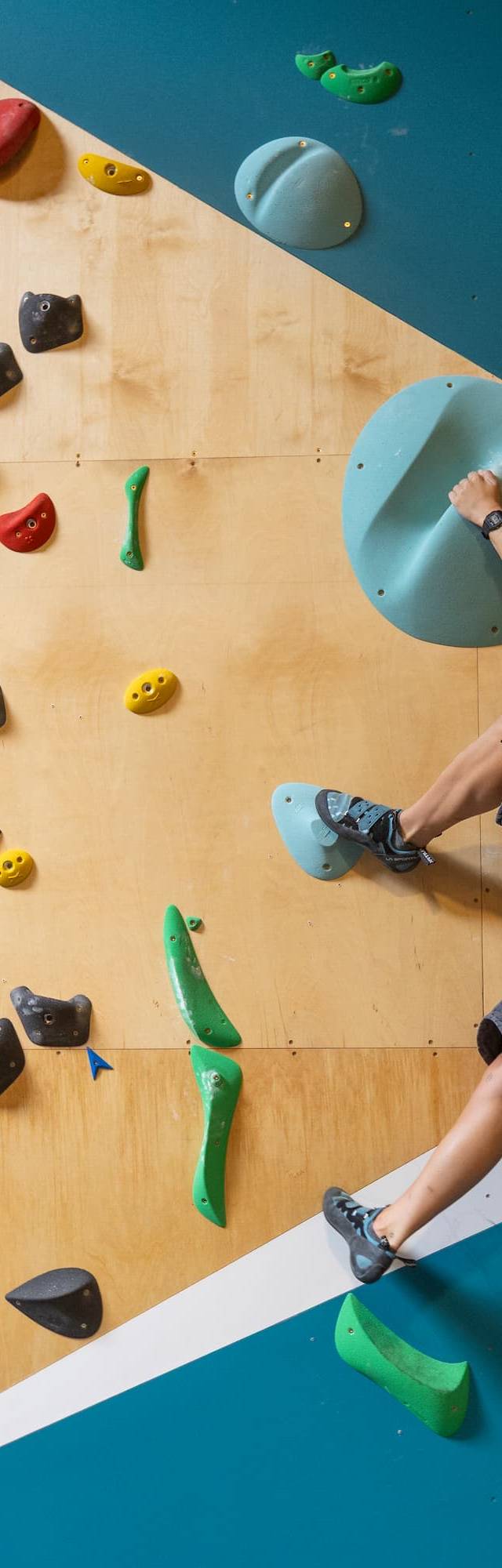Climber reaching for a hold on an overhang